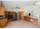 Spacious kitchen area with tiled flooring, ample cabinet space, and an open view to the living room at 585 Gasline Rd, Deland, FL 32724