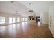 Large, open-concept living area with hardwood floors, multiple windows, and ceiling fans for added comfort at 585 Gasline Rd, Deland, FL 32724