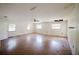 Large living room with wood floors, lots of windows, and ceiling fan at 585 Gasline Rd, Deland, FL 32724
