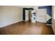 Bright living room with wood floors, geometric paint design, and closet at 585 Gasline Rd, Deland, FL 32724
