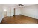 Large room with wood-look floors, ceiling fan and doors to other rooms at 585 Gasline Rd, Deland, FL 32724