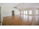 Spacious living room with hardwood floors, high ceilings, and natural light from windows and glass doors at 585 Gasline Rd, Deland, FL 32724