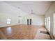 Open living area featuring hardwood floors, multiple windows for natural light, and ceiling fans for added comfort at 585 Gasline Rd, Deland, FL 32724