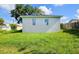 Small backyard studio with two windows and light gray exterior at 6120 Denson Dr, Orlando, FL 32808
