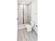 Shower stall with tile surround and toilet at 6120 Denson Dr, Orlando, FL 32808