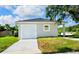Newly constructed home with attached garage and driveway at 6120 Denson Dr, Orlando, FL 32808