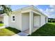 New construction home showcasing a side entrance and landscaping at 6120 Denson Dr, Orlando, FL 32808