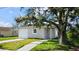 Newly constructed light gray house with a garage and driveway at 6120 Denson Dr, Orlando, FL 32808