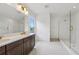 Modern bathroom with dual sinks, quartz countertops, and glass shower at 6232 Trailblaze Bnd, St Cloud, FL 34771