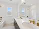 Modern bathroom featuring double sinks, white subway tile, and gold hardware at 6232 Trailblaze Bnd, St Cloud, FL 34771