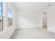 Bright bedroom with plush carpet, large window, and walk-in closet at 6232 Trailblaze Bnd, St Cloud, FL 34771