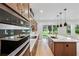 Modern kitchen featuring stainless appliances, a large island, and backyard view at 6232 Trailblaze Bnd, St Cloud, FL 34771