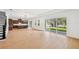 Bright open-plan living area with sleek wood floors and backyard views at 6232 Trailblaze Bnd, St Cloud, FL 34771