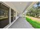 Covered patio featuring gray brick pavers, white columns, and lawn views at 6232 Trailblaze Bnd, St Cloud, FL 34771