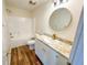 Clean bathroom with a tub, shower, and updated vanity at 654 Harbor Villa Ct, Clermont, FL 34711