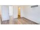 Well-lit bedroom with hardwood floors, a closet, and bathroom access at 654 Harbor Villa Ct, Clermont, FL 34711