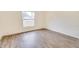 Simple bedroom with hardwood floors and large window at 654 Harbor Villa Ct, Clermont, FL 34711
