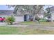 House exterior featuring a well-maintained lawn, driveway, and landscaping at 654 Harbor Villa Ct, Clermont, FL 34711