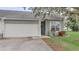 Attractive house exterior with a garage and neatly landscaped front yard at 654 Harbor Villa Ct, Clermont, FL 34711