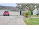 House exterior with two-car garage and landscaping at 654 Harbor Villa Ct, Clermont, FL 34711