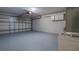 Attached garage with painted floor and overhead storage at 654 Harbor Villa Ct, Clermont, FL 34711