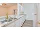 Kitchen with granite countertops, stainless steel sink, and white cabinets at 654 Harbor Villa Ct, Clermont, FL 34711