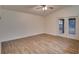 Spacious living area featuring hardwood floors and sliding doors to patio at 654 Harbor Villa Ct, Clermont, FL 34711