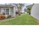 Landscaped side yard with green grass at 654 Harbor Villa Ct, Clermont, FL 34711