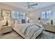 Cozy bedroom with ceiling fan and striped bedding at 801 E 8Th Ave, New Smyrna Beach, FL 32169