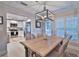 Light and airy dining room with wooden table and kitchen view at 801 E 8Th Ave, New Smyrna Beach, FL 32169