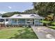 Quaint light blue house with a front porch and lush green lawn at 801 E 8Th Ave, New Smyrna Beach, FL 32169