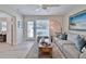 Living area features a gray sofa, coffee table, and access to the outdoors at 801 E 8Th Ave, New Smyrna Beach, FL 32169