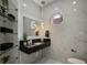 Modern bathroom with floating vanity, glass shelves, and marble tile at 8010 Firenze Blvd, Orlando, FL 32836