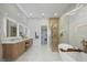 Elegant bathroom with walk-in shower, freestanding tub, and marble finishes at 8010 Firenze Blvd, Orlando, FL 32836