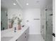 Spa-like bathroom with double vanity, large mirror, and frameless shower at 8010 Firenze Blvd, Orlando, FL 32836