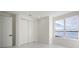 Bright bedroom with large window offering water views and double doors leading to closet at 8010 Firenze Blvd, Orlando, FL 32836