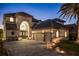 Elegant two-story home with a three-car garage and manicured landscaping at 8010 Firenze Blvd, Orlando, FL 32836