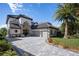 Two-story house with a gray tile roof and paver driveway at 8010 Firenze Blvd, Orlando, FL 32836