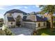 Two-story house featuring a large driveway and a lush green lawn at 8010 Firenze Blvd, Orlando, FL 32836