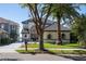 Two-story house with a gray tile roof and lush landscaping at 8010 Firenze Blvd, Orlando, FL 32836