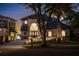 Stunning two-story home at night with elegant entryway at 8010 Firenze Blvd, Orlando, FL 32836