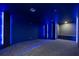 Dark, dramatic home theater with blue accent lighting at 8010 Firenze Blvd, Orlando, FL 32836