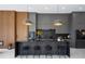 Modern kitchen with dark cabinetry, marble countertops, and island seating at 8010 Firenze Blvd, Orlando, FL 32836