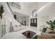 Open concept living space with a two-story high ceiling and elegant staircase at 8010 Firenze Blvd, Orlando, FL 32836