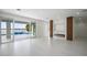 Spacious living room with fireplace, water views, and sliding doors to pool area at 8010 Firenze Blvd, Orlando, FL 32836