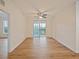Bright living room with hardwood floors and sliding glass door to balcony at 8010 Tuscany Way # 5302, Davenport, FL 33896
