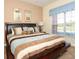 King-size bed in a Primary bedroom with large window and view at 8938 Majesty Palm Rd, Kissimmee, FL 34747