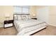 Spacious Primary bedroom with a king-size bed and striped bedding at 8938 Majesty Palm Rd, Kissimmee, FL 34747