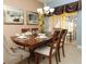 Elegant dining room with a large wooden table and six chairs at 8938 Majesty Palm Rd, Kissimmee, FL 34747