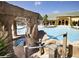 Resort-style pool and spa with a rock waterfall feature at 8938 Majesty Palm Rd, Kissimmee, FL 34747